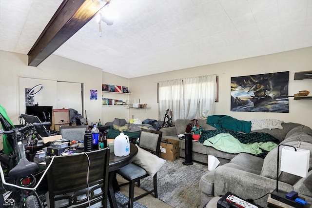 carpeted living room featuring vaulted ceiling with beams