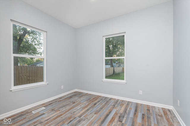 empty room with hardwood / wood-style flooring