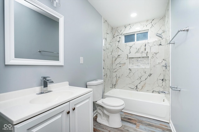 full bathroom with vanity, toilet, tiled shower / bath combo, and wood-type flooring