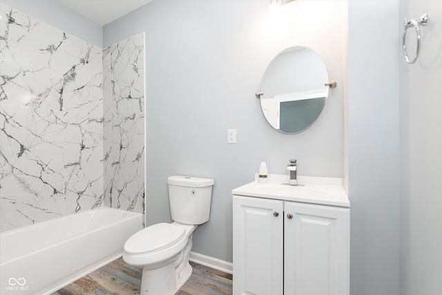 full bathroom with toilet, hardwood / wood-style floors, tiled shower / bath combo, and vanity