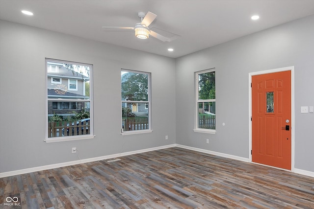 spare room featuring dark wood-type flooring and ceiling fan