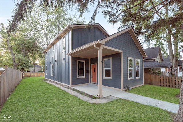 view of front facade featuring a front lawn and a patio