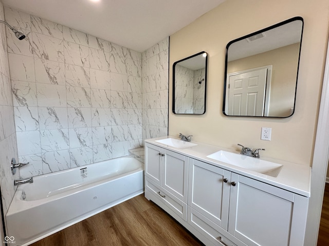 bathroom featuring vanity, tiled shower / bath, and hardwood / wood-style flooring