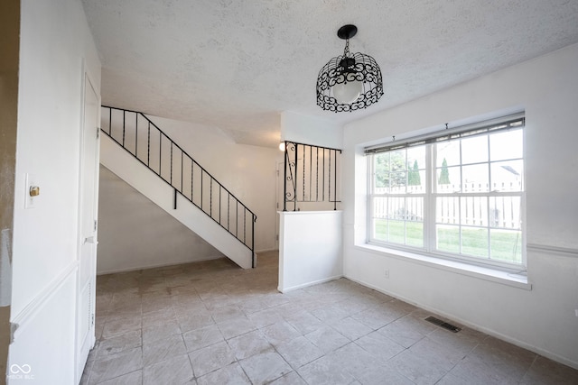 unfurnished living room featuring a textured ceiling