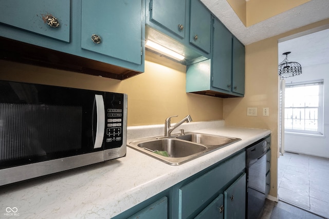 kitchen with tile patterned flooring, blue cabinets, sink, and dishwasher