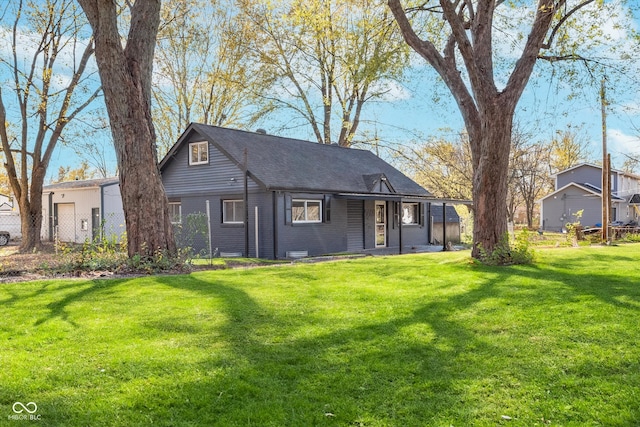 rear view of house featuring a yard