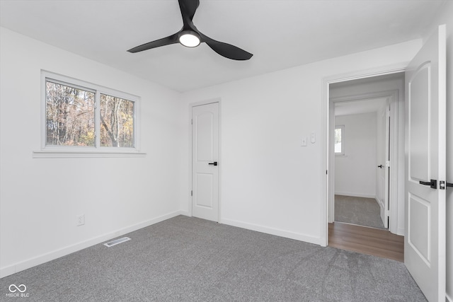 unfurnished bedroom with carpet flooring, ceiling fan, and a closet