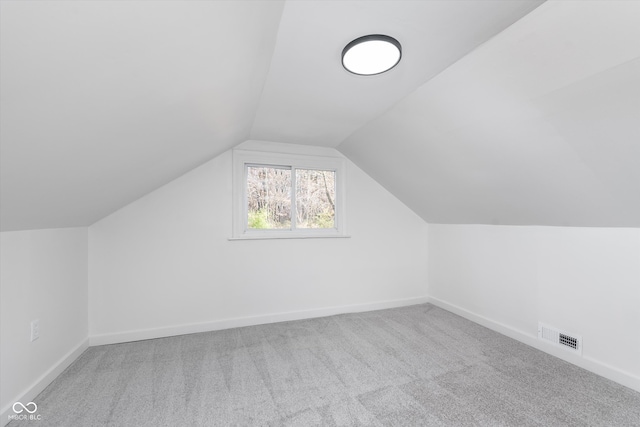 bonus room featuring carpet flooring and vaulted ceiling