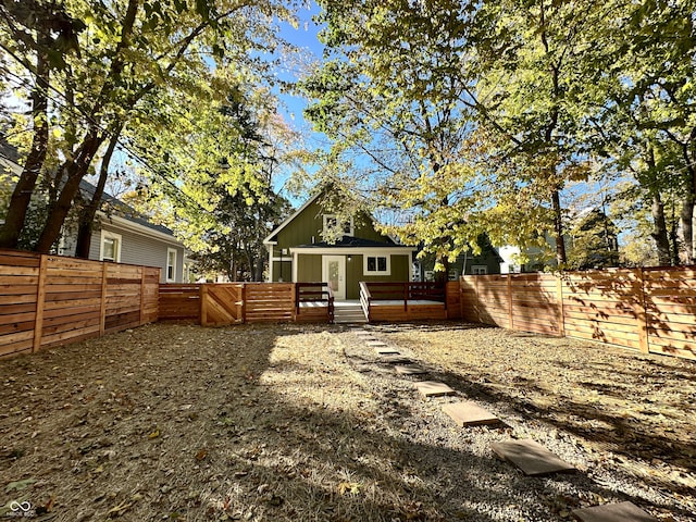 back of house featuring a wooden deck