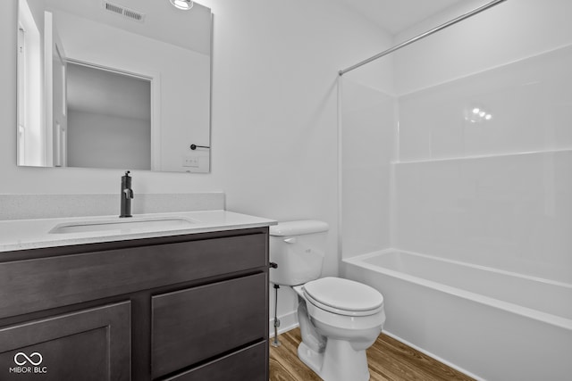 full bathroom with toilet, vanity,  shower combination, and hardwood / wood-style flooring