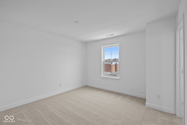 spare room with light carpet