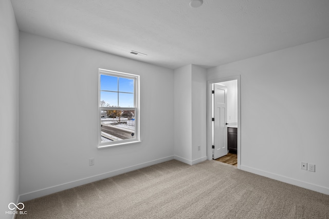 spare room with light colored carpet