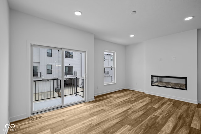 unfurnished living room featuring light hardwood / wood-style floors