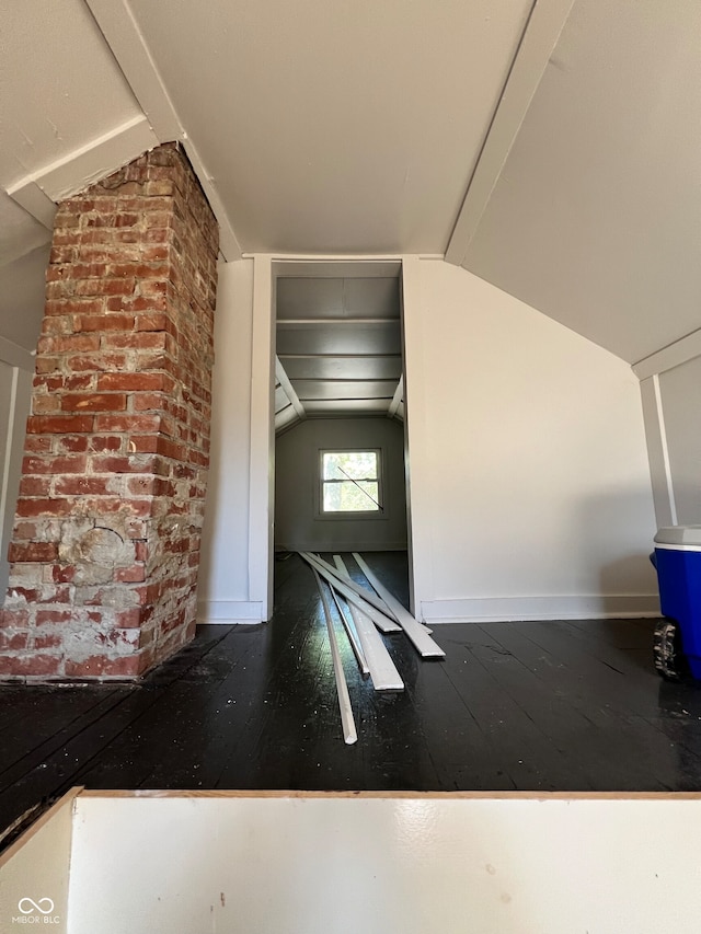 additional living space with lofted ceiling and dark wood-type flooring