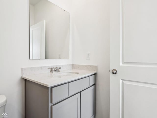 half bathroom featuring toilet and vanity