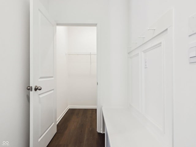 mudroom with baseboards and dark wood-type flooring