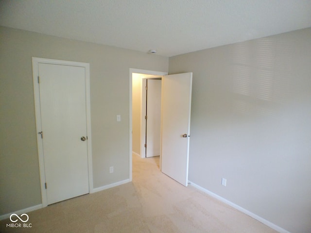 unfurnished bedroom featuring light colored carpet