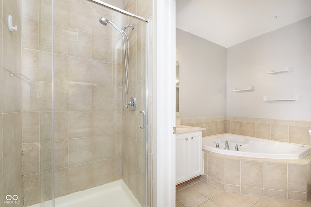 bathroom featuring vanity, plus walk in shower, and tile patterned flooring