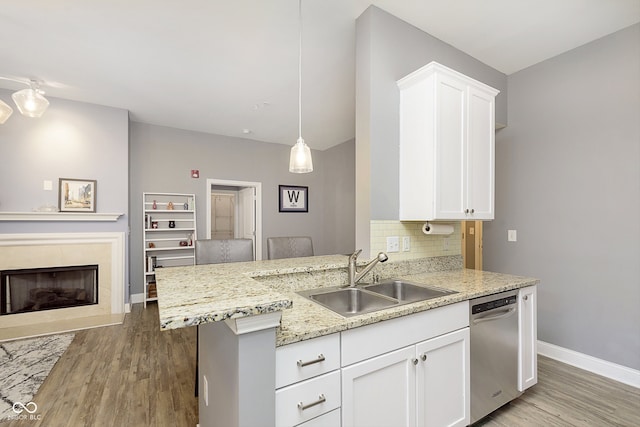 kitchen featuring sink, dishwasher, and white cabinets