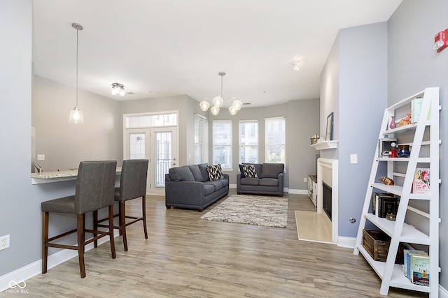 living room featuring an inviting chandelier and hardwood / wood-style flooring