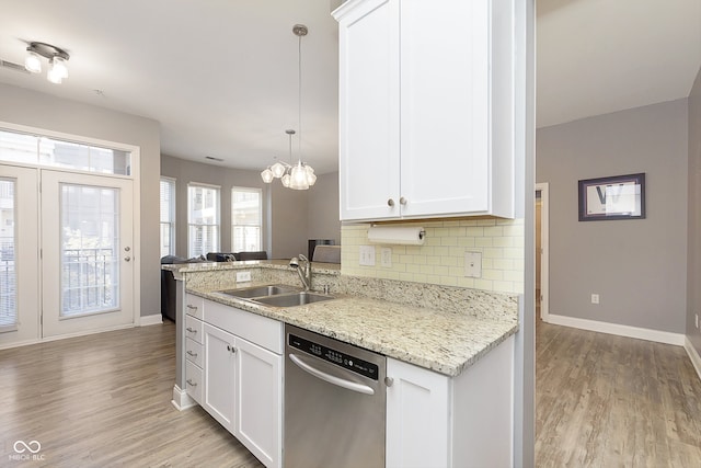 kitchen with white cabinetry, dishwasher, sink, and light wood-type flooring