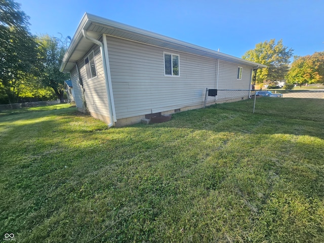 view of side of home with a lawn