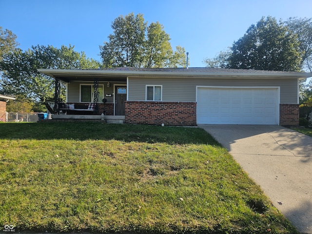 view of front of home with a front lawn, covered porch, and a garage