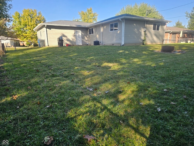 rear view of property featuring a lawn