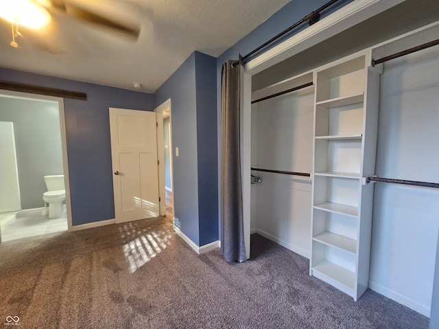 unfurnished bedroom featuring ceiling fan, connected bathroom, and carpet