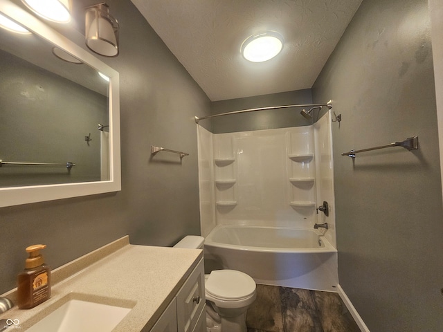 full bathroom with a textured ceiling, tub / shower combination, vanity, and toilet