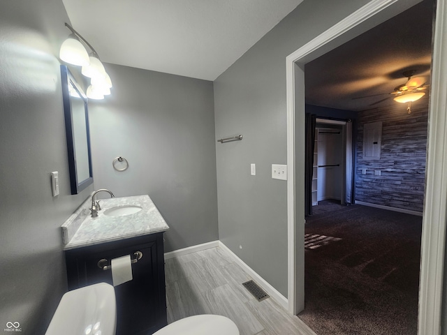 bathroom featuring ceiling fan, vanity, and toilet