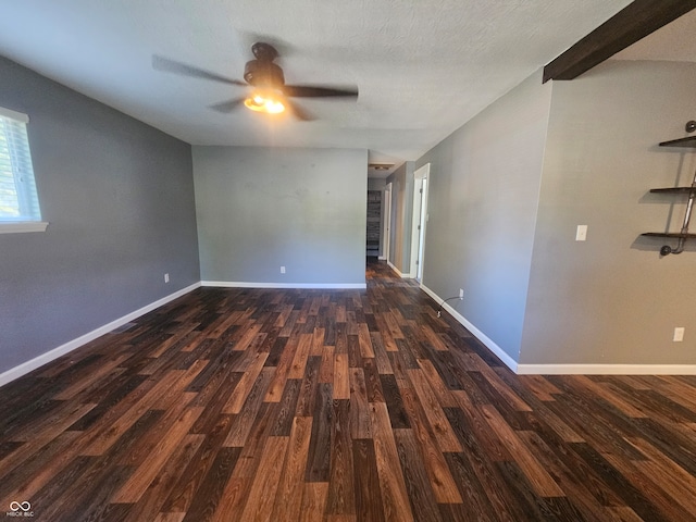 spare room with dark hardwood / wood-style flooring, a textured ceiling, and ceiling fan