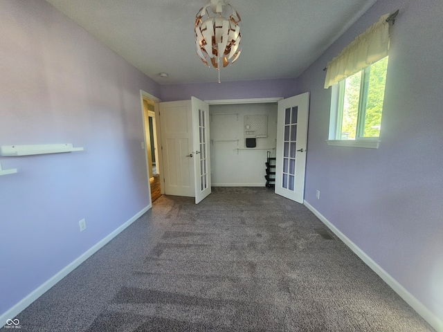 spare room featuring french doors and carpet flooring