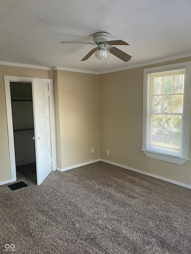 unfurnished bedroom featuring crown molding, carpet, and ceiling fan