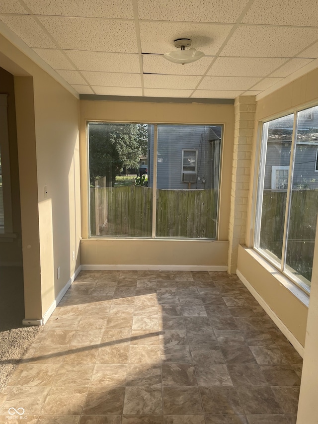 unfurnished sunroom with plenty of natural light and a paneled ceiling