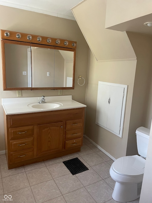 bathroom featuring toilet, tile patterned flooring, and vanity