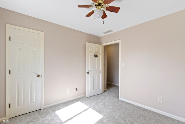 unfurnished bedroom with ceiling fan and light carpet