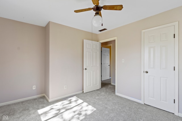 unfurnished bedroom with ceiling fan and light carpet