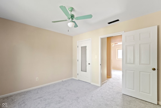 spare room with ceiling fan and light colored carpet