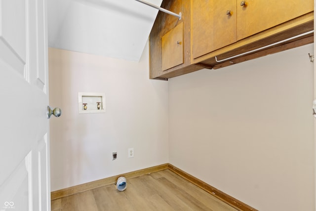 clothes washing area with cabinets, electric dryer hookup, hookup for a washing machine, and light wood-type flooring