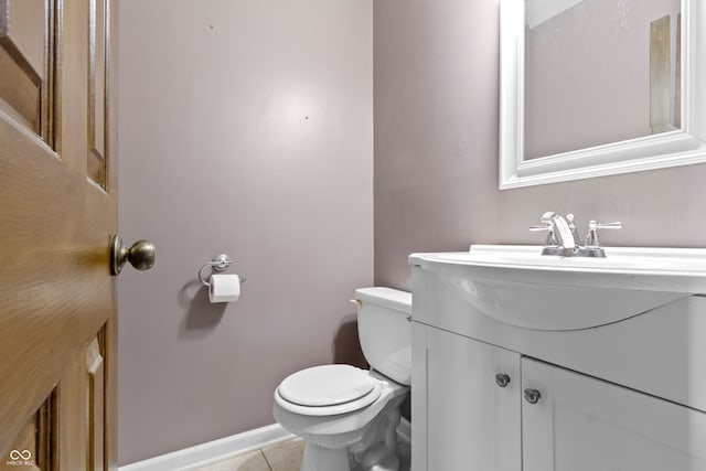 bathroom with toilet, tile patterned floors, and vanity