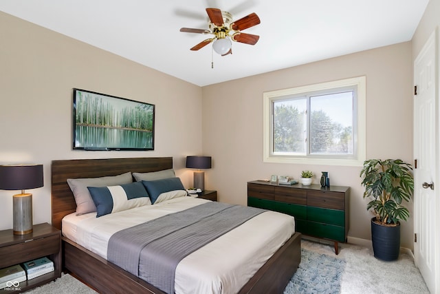 bedroom with ceiling fan and light carpet