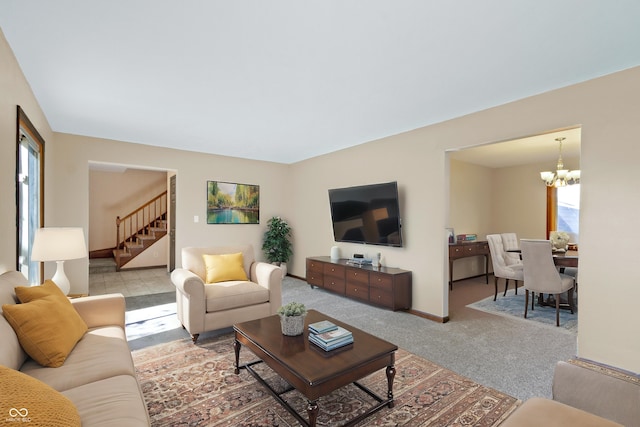 carpeted living room with a chandelier