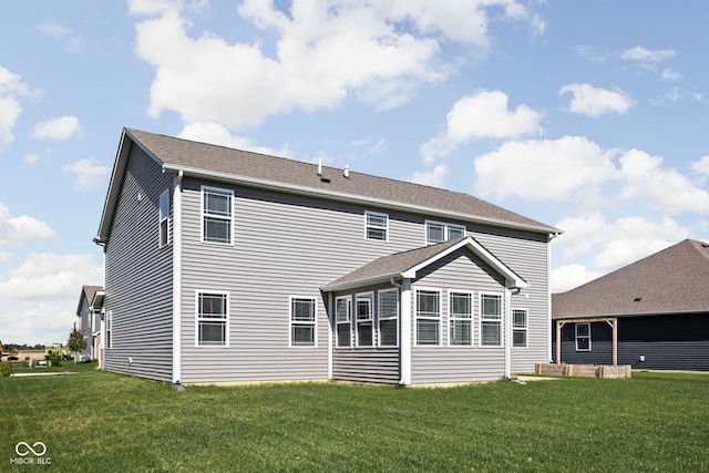 rear view of house with a lawn