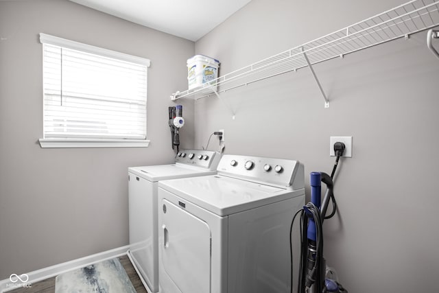 washroom with washing machine and dryer and wood-type flooring