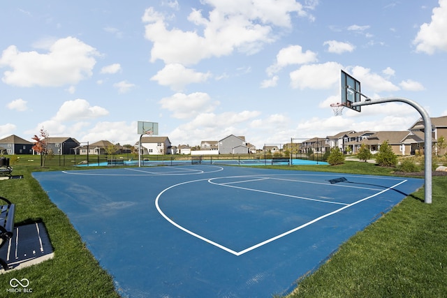 view of basketball court featuring a lawn