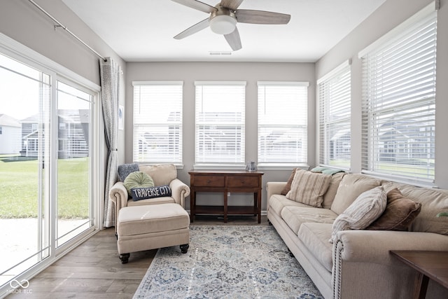 sunroom / solarium with a wealth of natural light and ceiling fan