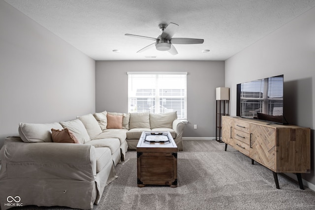 living room with carpet, a textured ceiling, and ceiling fan