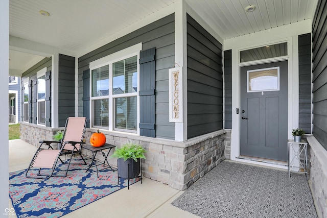 view of exterior entry with covered porch