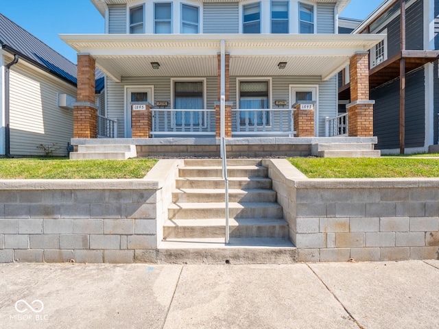 doorway to property featuring covered porch